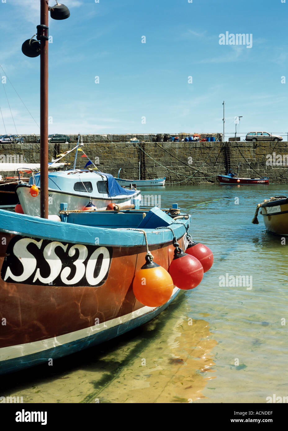 Fishing boat moored in the harbour at Mousehole village near Penzance in West Cornwall in the UK Stock Photo