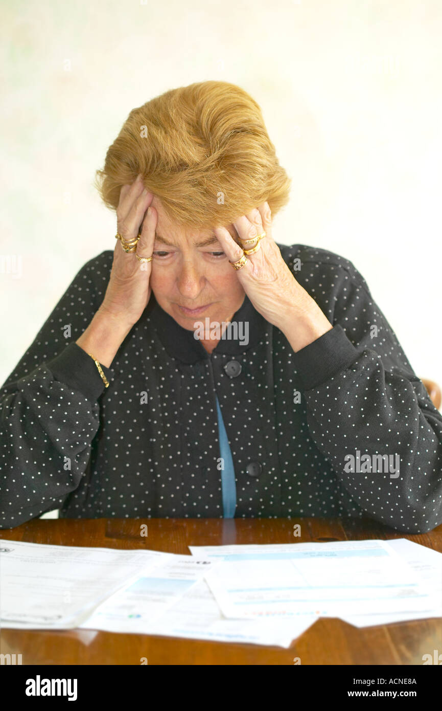 pensioner worrying about paying her heating and other bills. Stock Photo