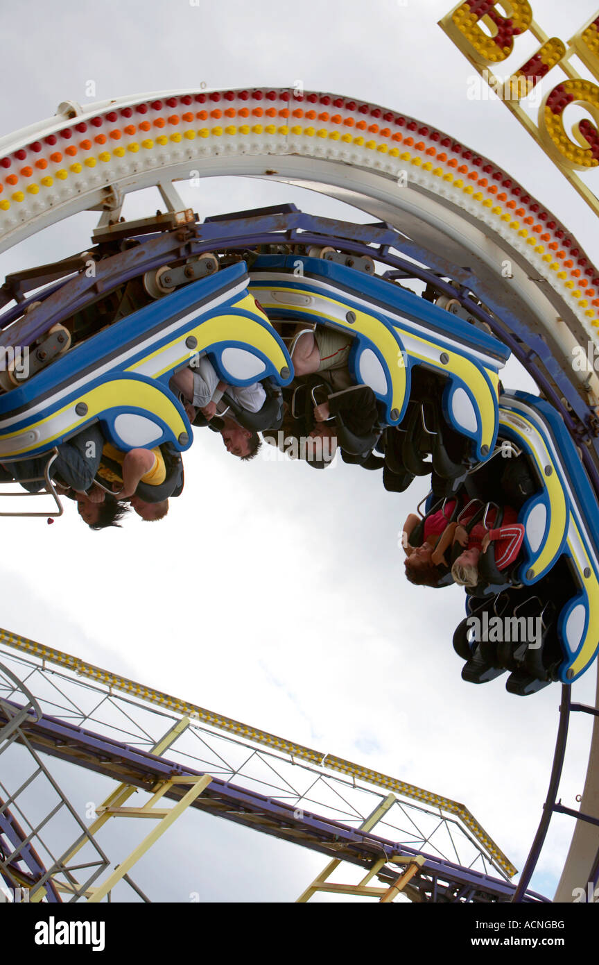 tourists and holidaymakers upside down on the big dipper rollercoaster at Barrys amusements in Portrush Stock Photo