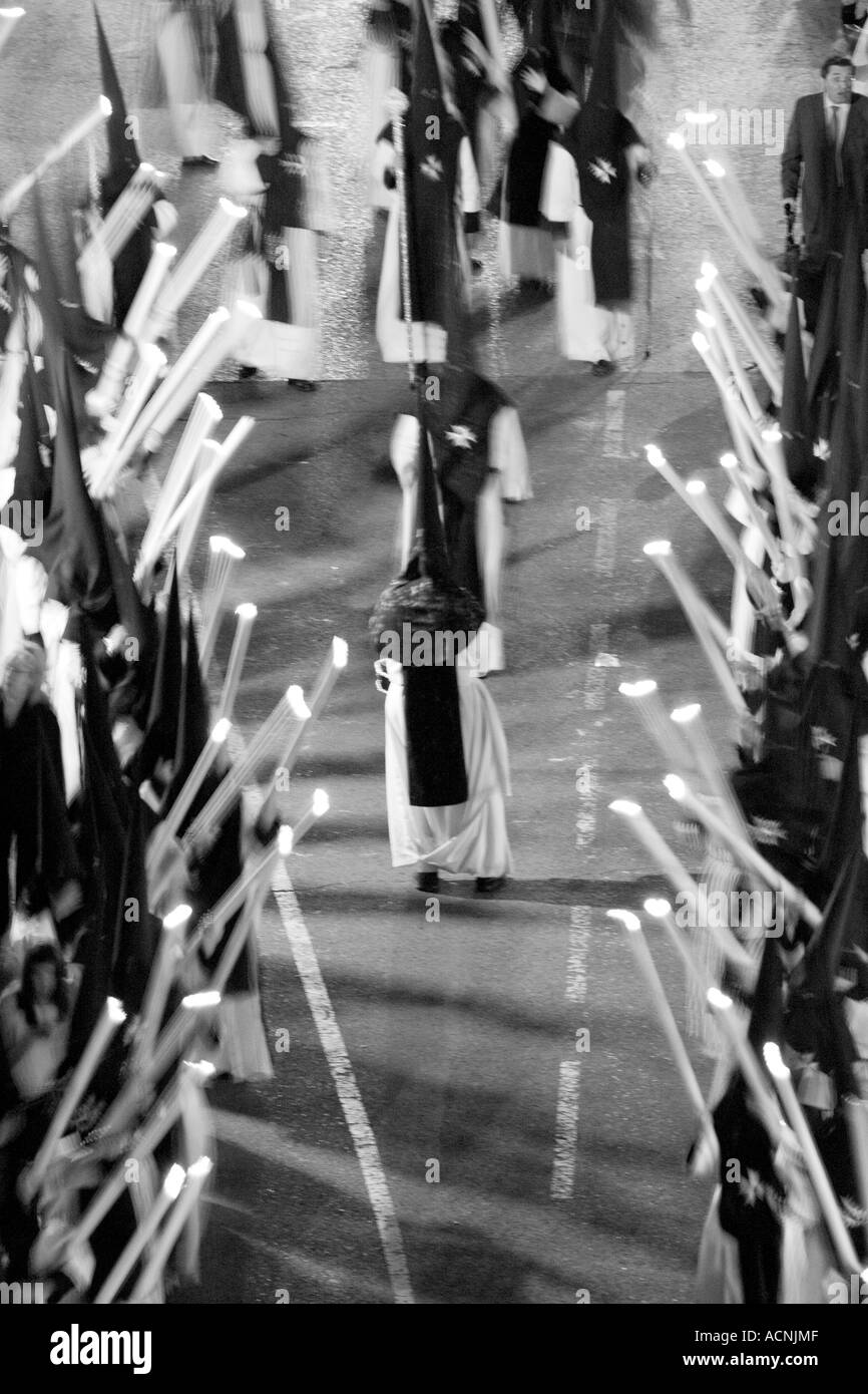 Row of penitents bearing candles during an Easter procession, Seville, Spain, 2006 Stock Photo