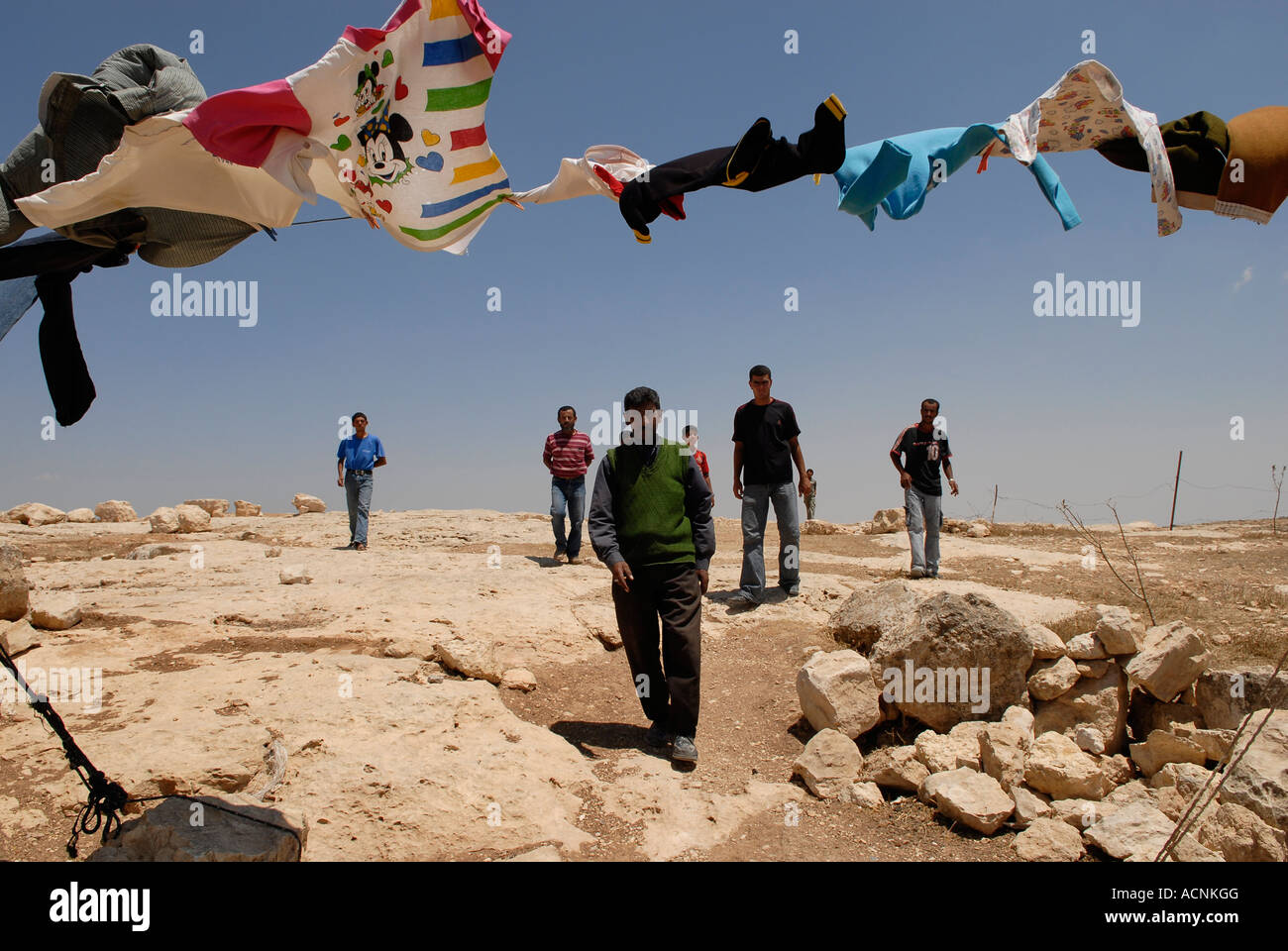 Palestinian villagers walking in Khirbat al-Mufaqara cave hamlet in the ...