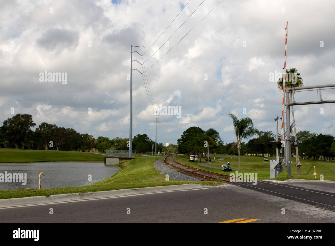 Railroad Tracks running through the middle of a Golf Course Stock Photo