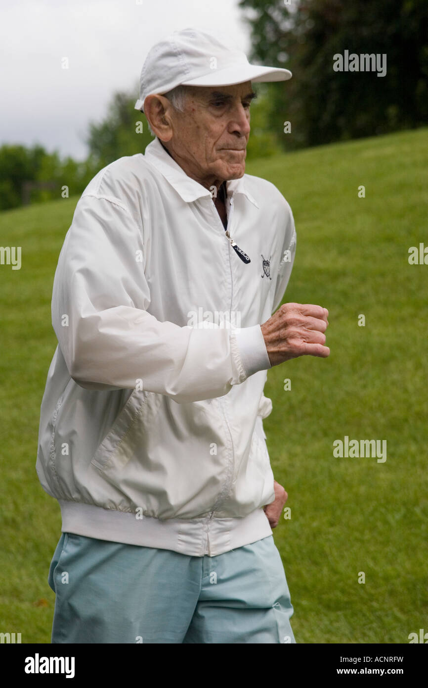 Elderly retired man age 87 walking in relay walking race in a Senior Olympics tournament Stock Photo