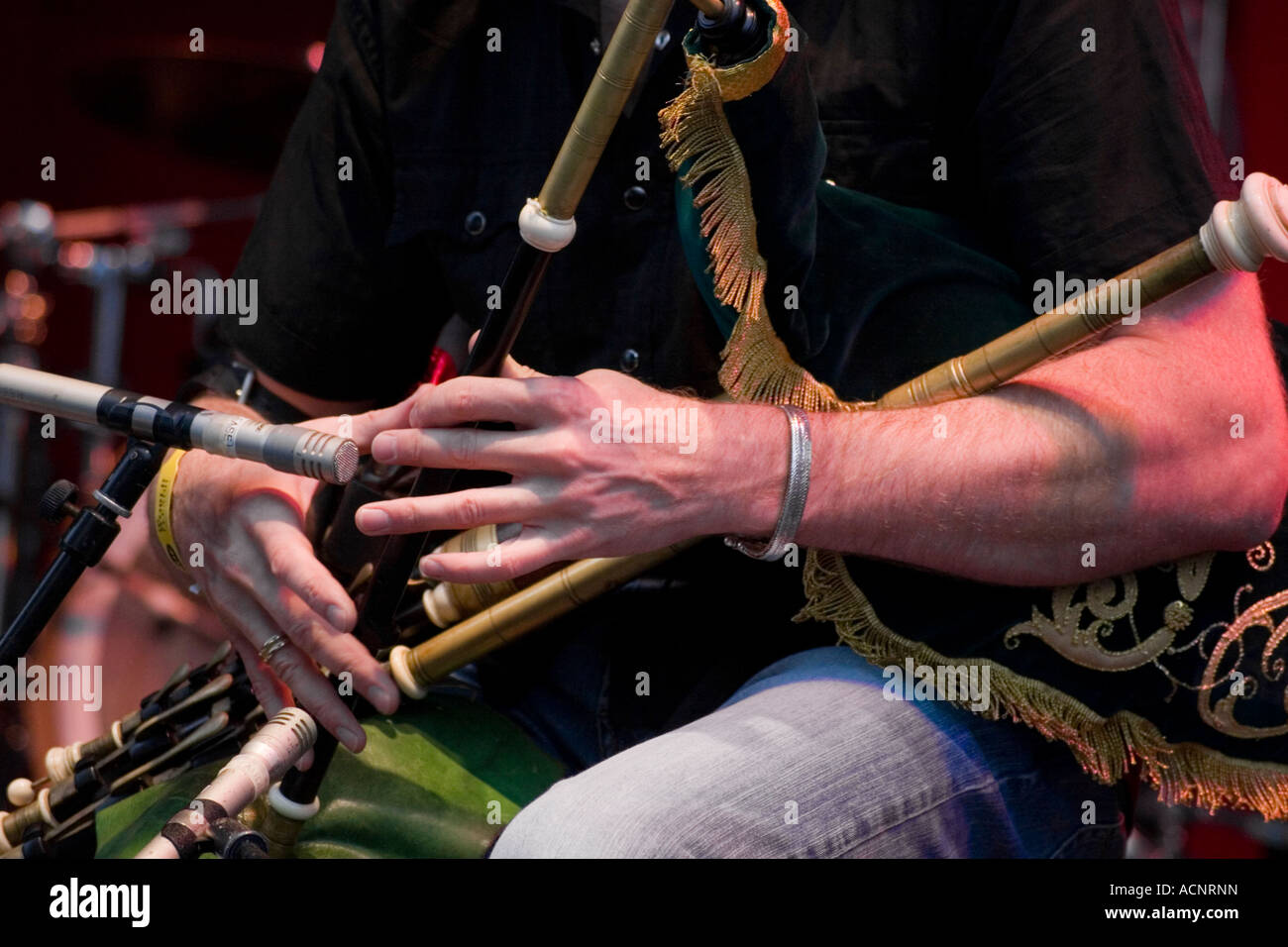 Irish traditional musician playing uilleann pipes live in concert Stock Photo