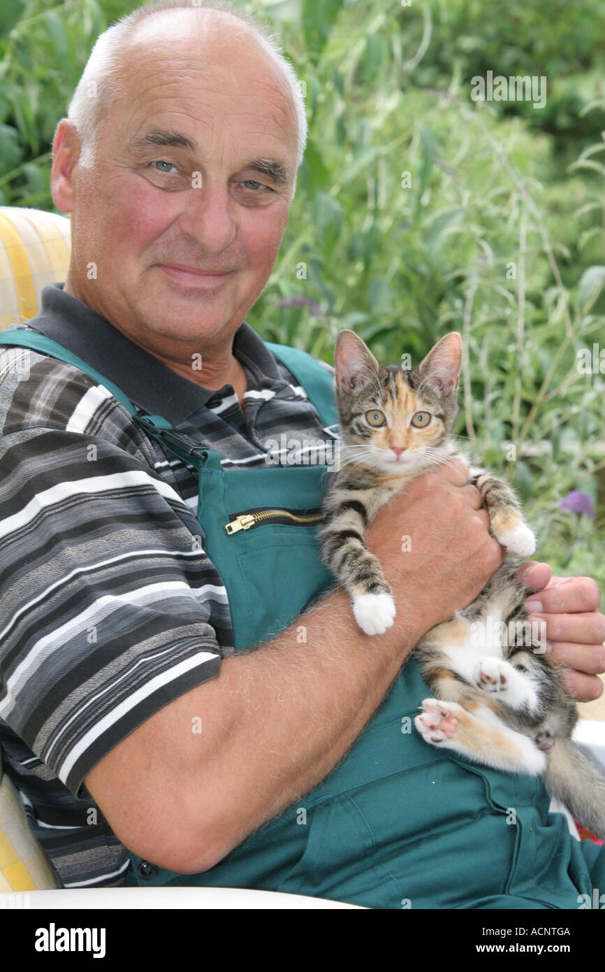 Old man with young Cat - Älterer Mann mit junger Katze Stock Photo