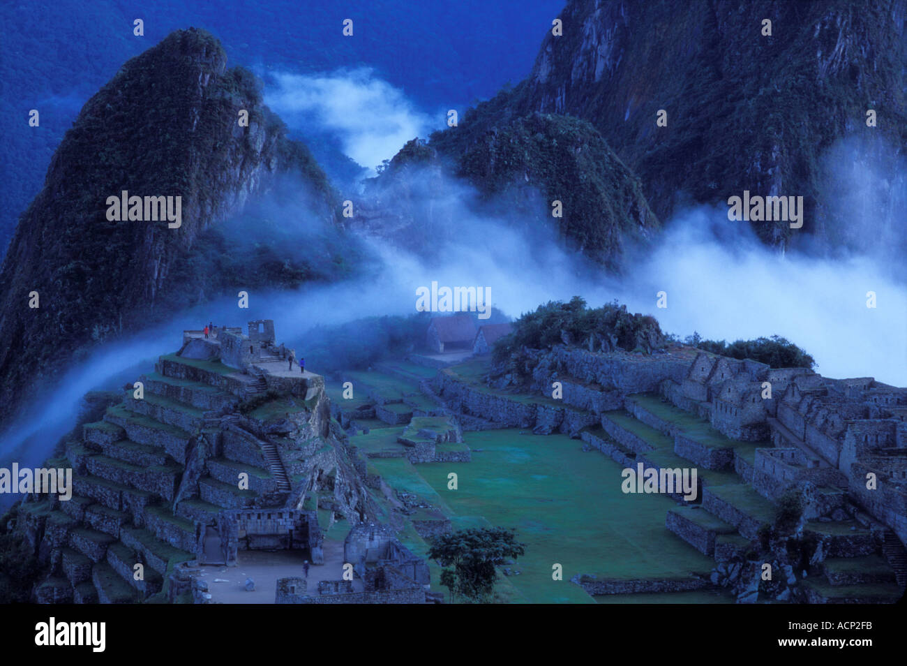 Ancient ruins of Machu Picchu with the Andes Mountains in mist Peru ...
