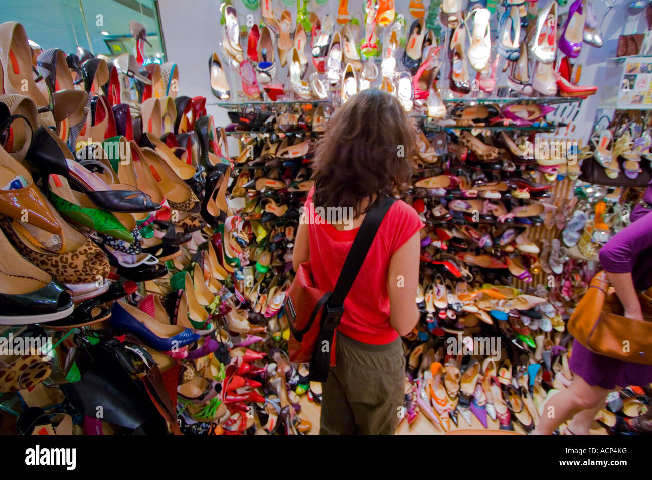 Young Woman Shopping in a Packed Shoe Store, Hong Kong Stock Photo