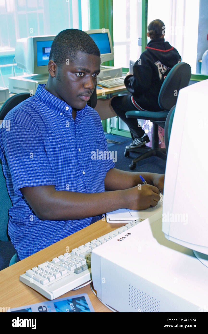 Teenage male student working with computer in computer suite hi-res ...