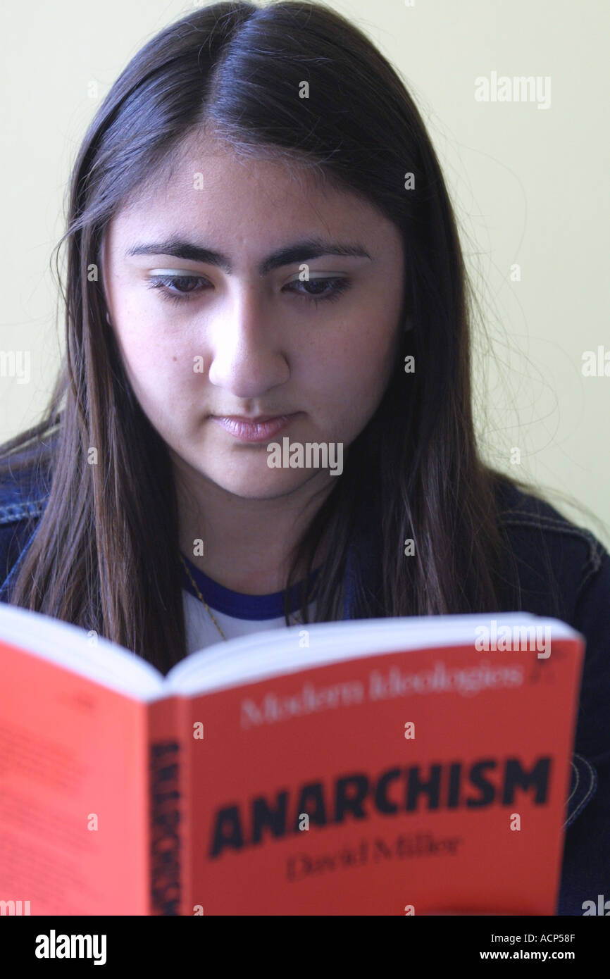 Female Student looking at Anarchism book at Sixth form college South London GB UK Stock Photo