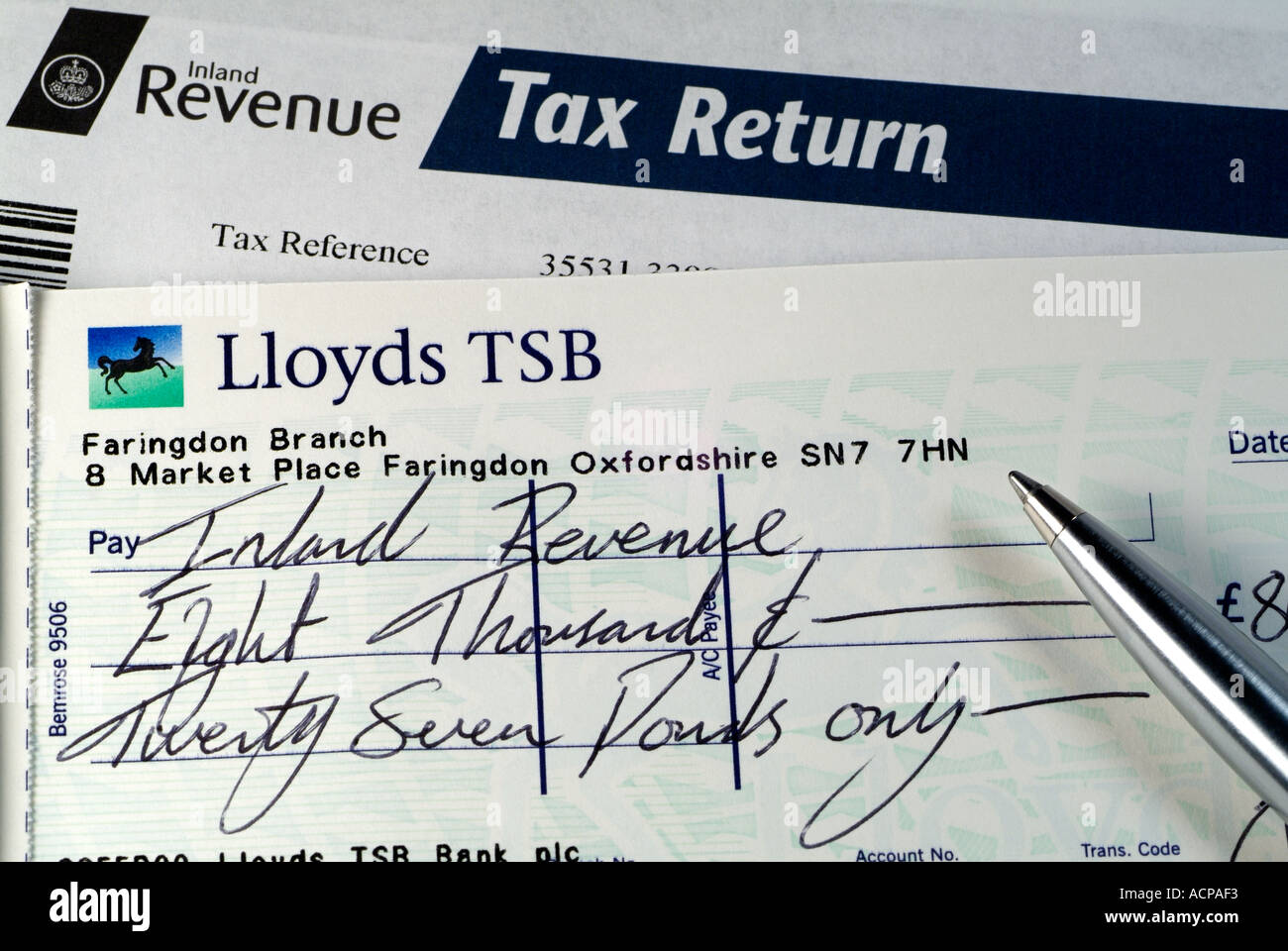 Cheque Made Out to the United Kingdom Inland Revenue to Pay a Tax Bill, Close Up. Stock Photo