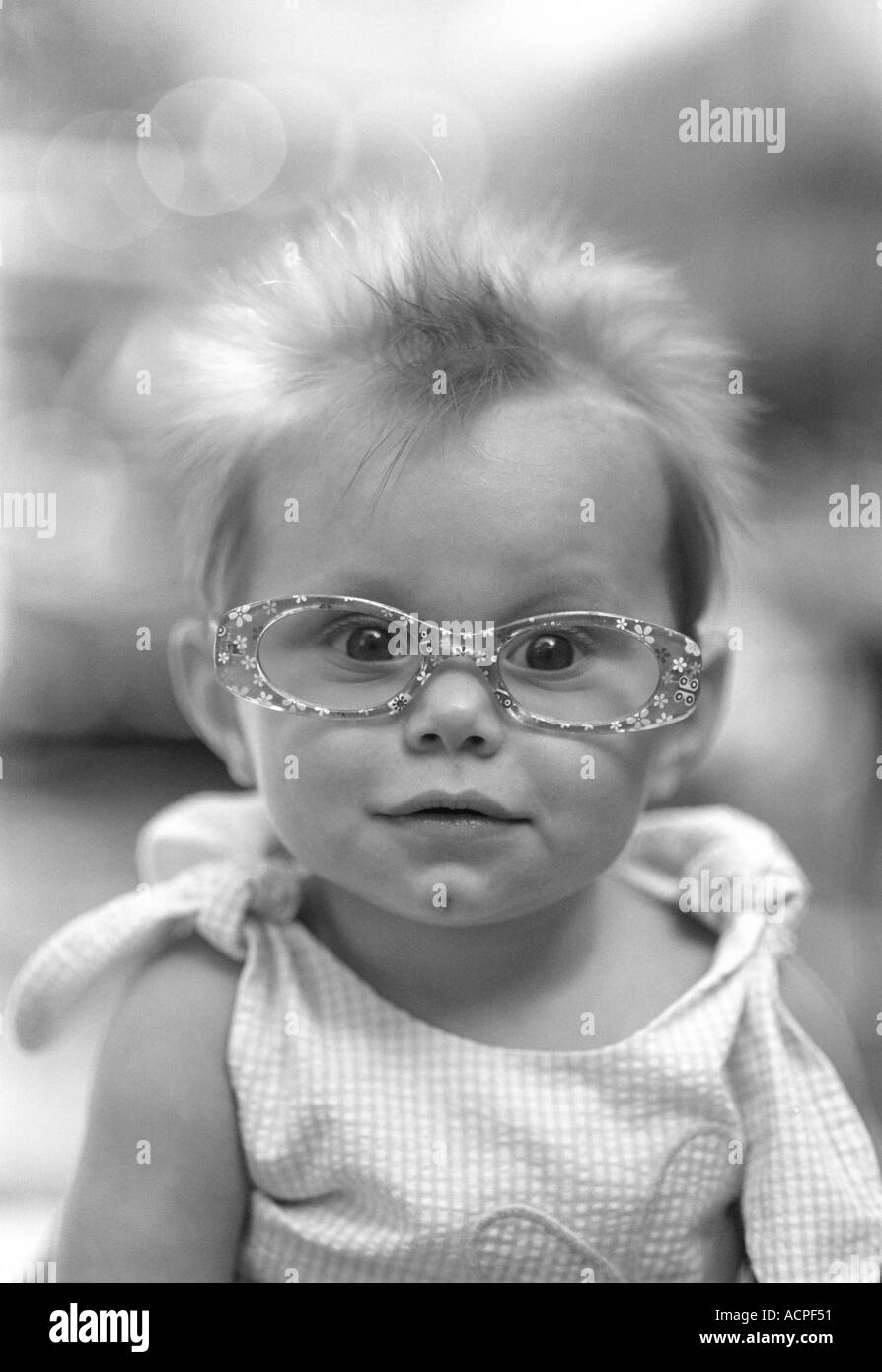 Cute baby small girl wearing funny glasses smiling Stock Photo