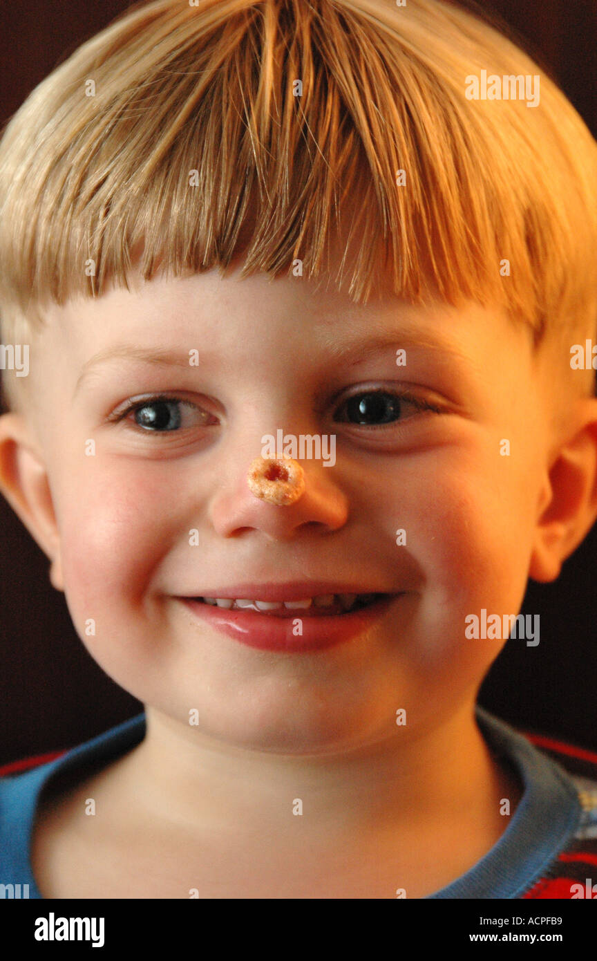 Small boy with Cheerio on Nose Stock Photo