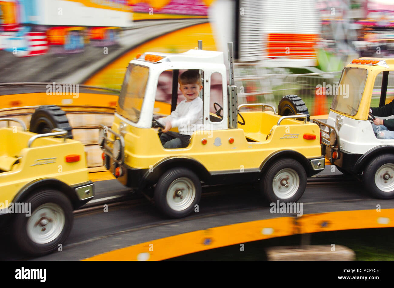 Child rides a carnival ride in the USA Stock Photo - Alamy