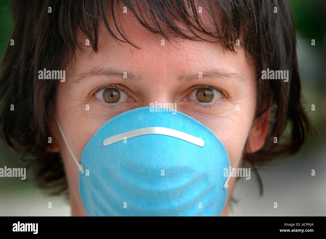 Woman wearing sanitary sterile mask for hygienic reasons over mouth and ...