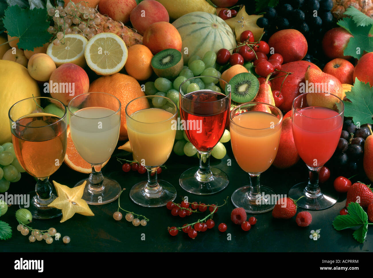 Glass of fruits and vegetables juice aligned in front of varied fruits Stock Photo Alamy