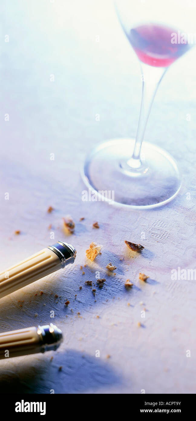 End of a meal close up on wine glass foot crumbs on white tablecloth
