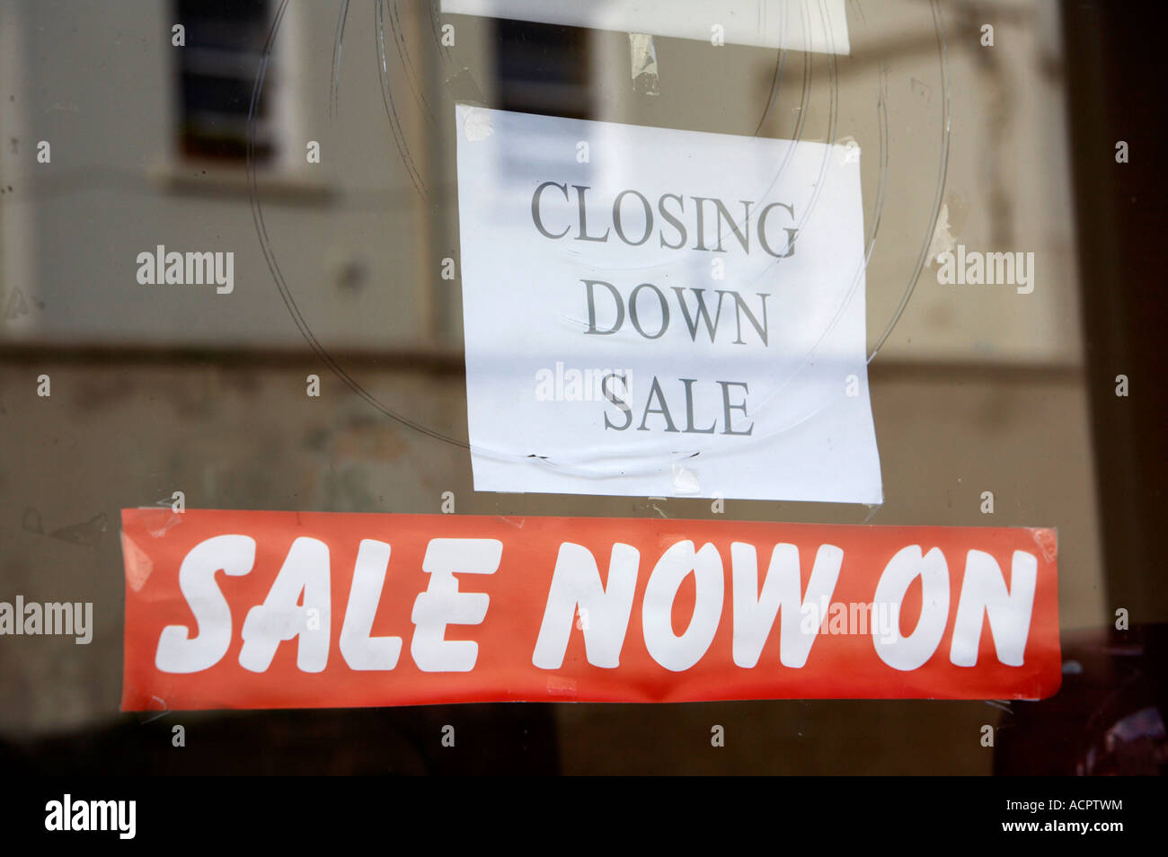 closing down sale sign in a shop window and red sale now on banner ...