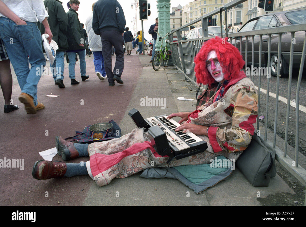 A STREET ENTERTAINER DRESSED AS A CLOWN ON THE SEA FRONT IN BRIGHTON SUSSEX UK Stock Photo