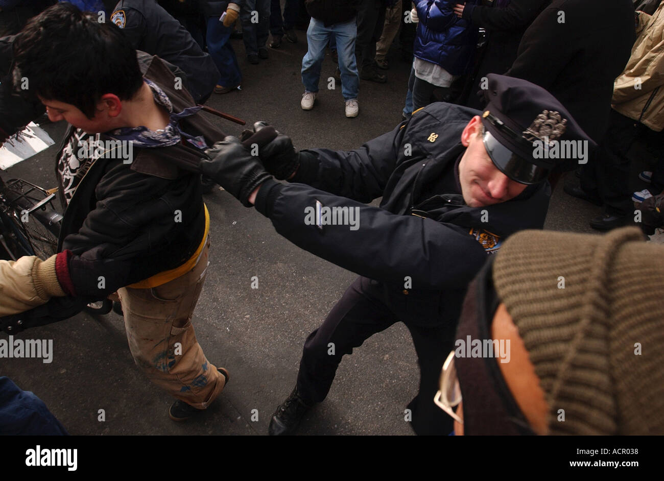 Police officer arresting protester during anti war protests in New York City Stock Photo