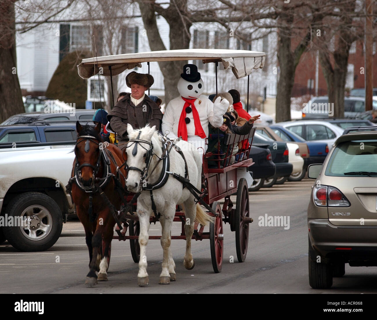 horse drwan carraige with man wearing snowman costume during winter festival Stock Photo