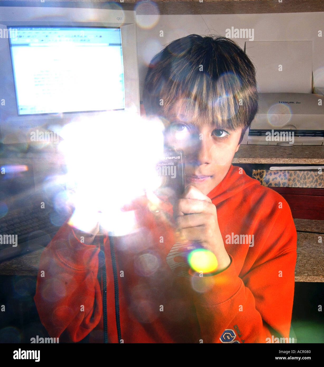 Boy taking photo with digital camera flash going off Stock Photo