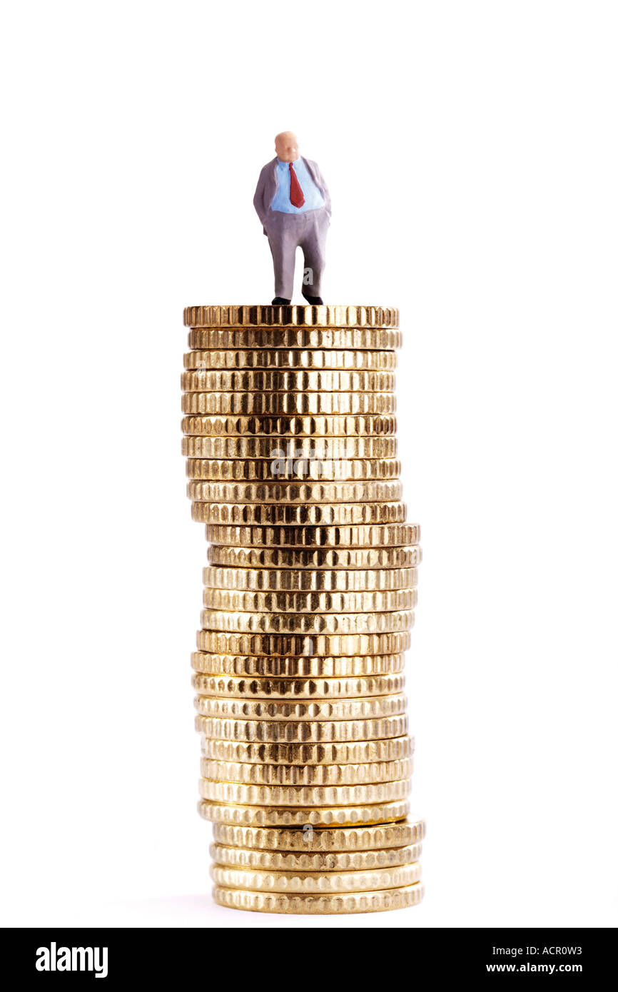 Figurine on pile of coins Stock Photo