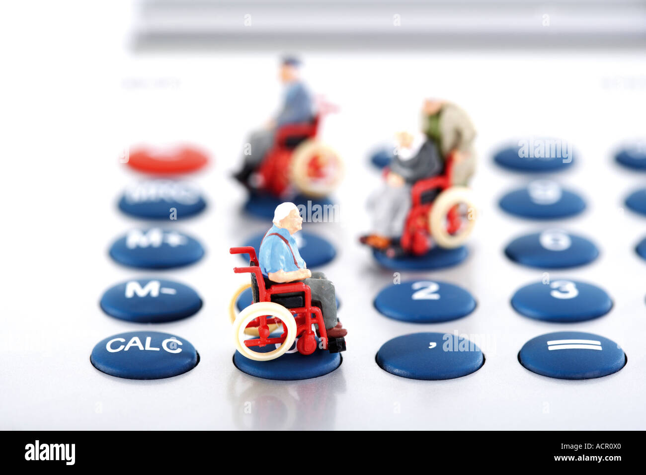 Figurine on wheelchairs on calculator Stock Photo