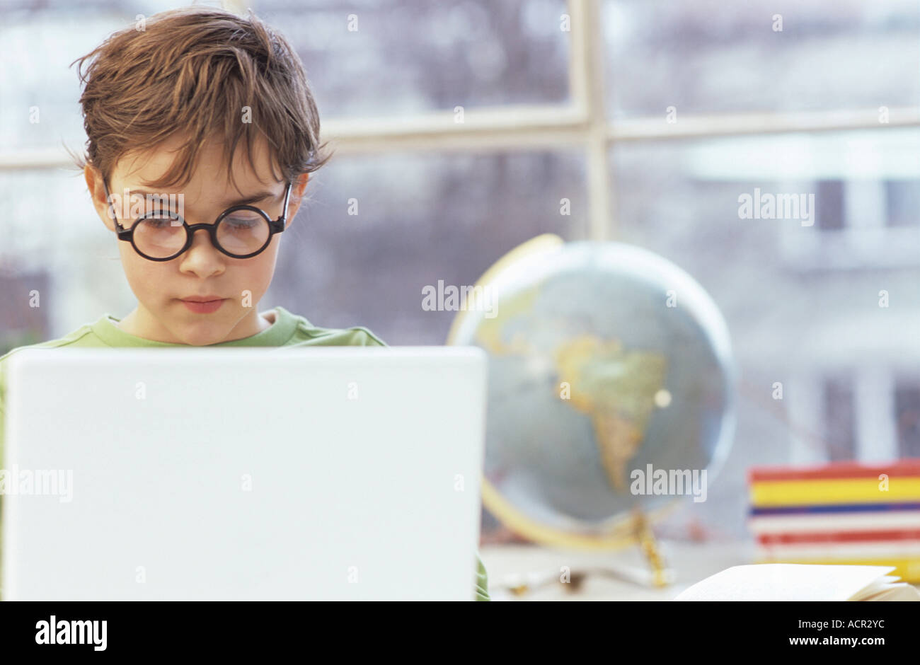 Boy (8-9) using laptop Stock Photo