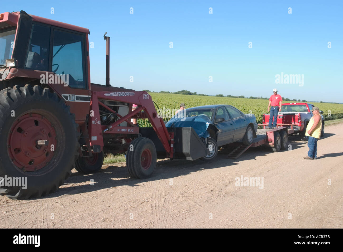Traffic accident in rural Nebraska Farmer with a tractor helping out by