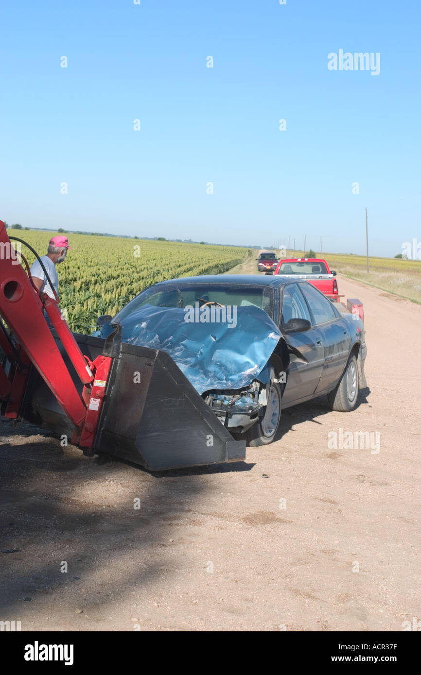Traffic accident in rural Nebraska Farmer with a tractor helping out by