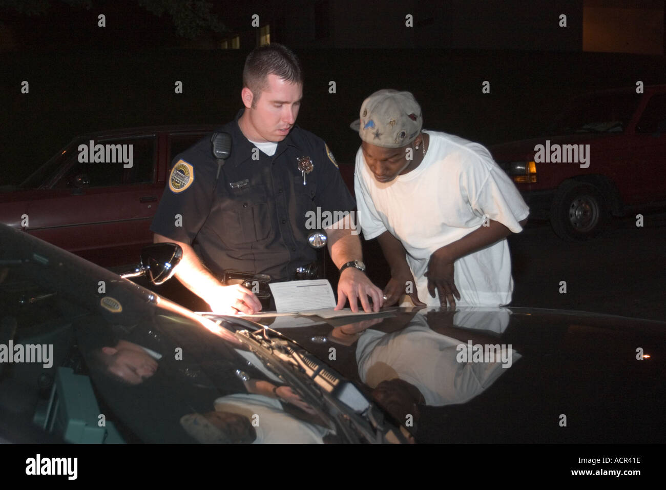 Traffic stop late at night Officer is explaining ticket complaint to the driver of the stopped