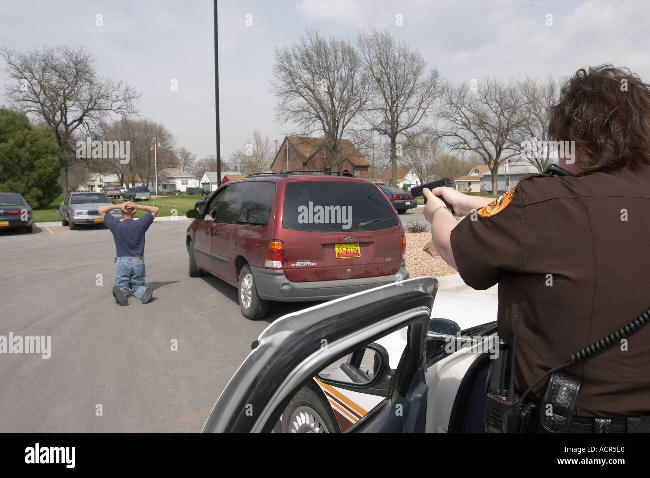 Felony traffic stop. Female deputy sheriff stopping motorist Stock