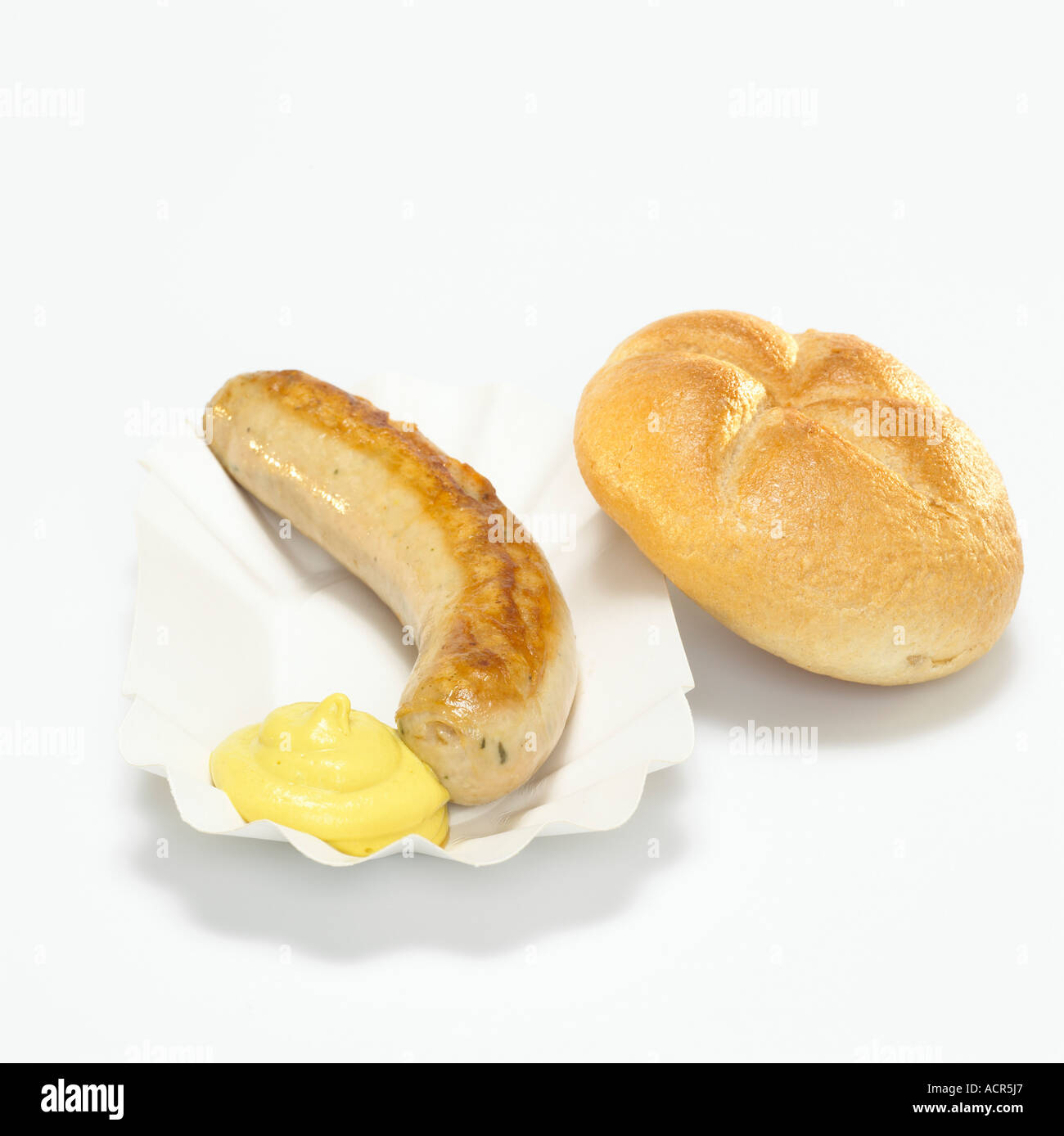 German Bratwurst, fried sausage and bread with mustard in paper plate