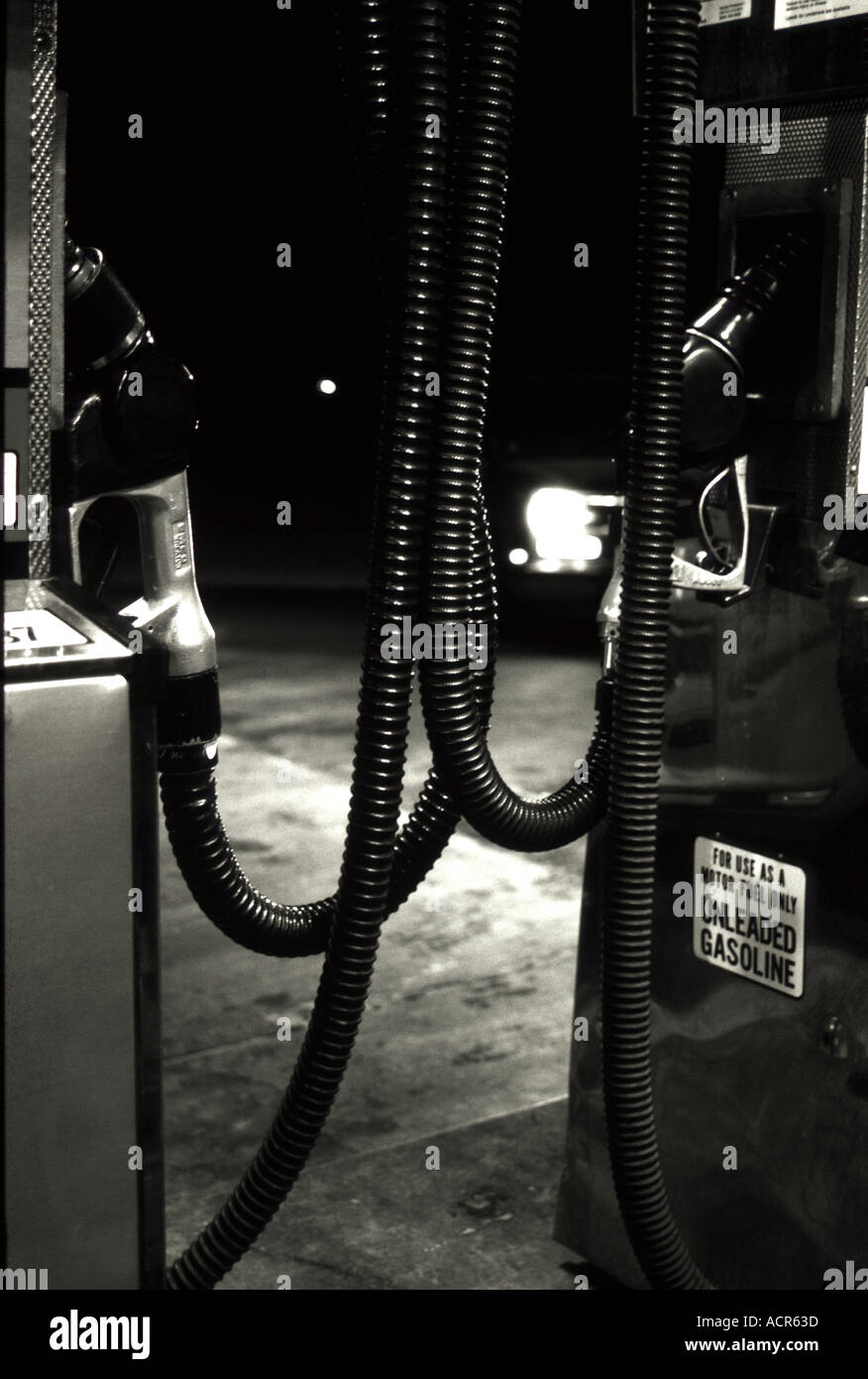A black and white image of petrol pumps in California USA at night