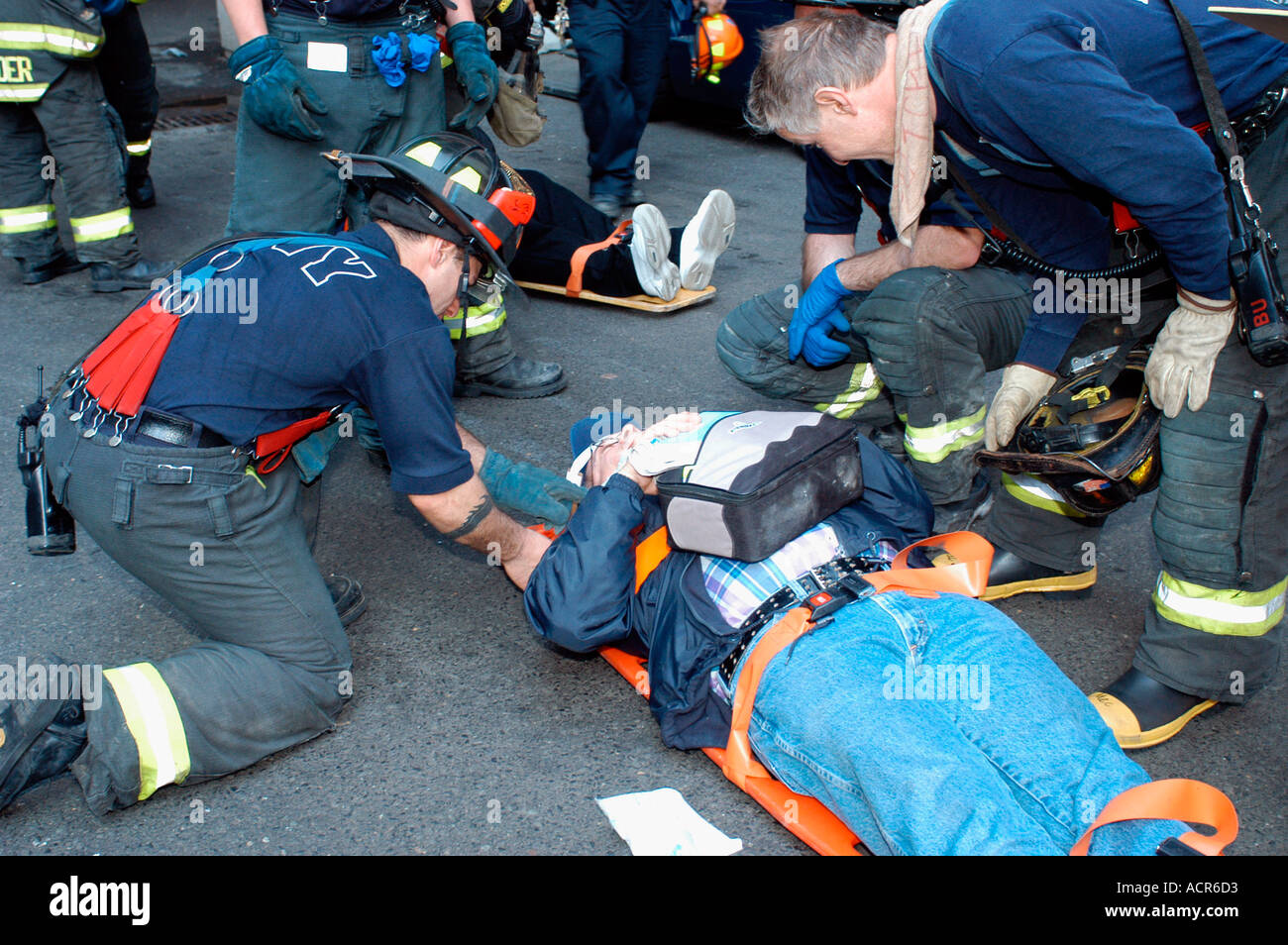 Emergency workers treat injured commuters after an Amtrak train ...