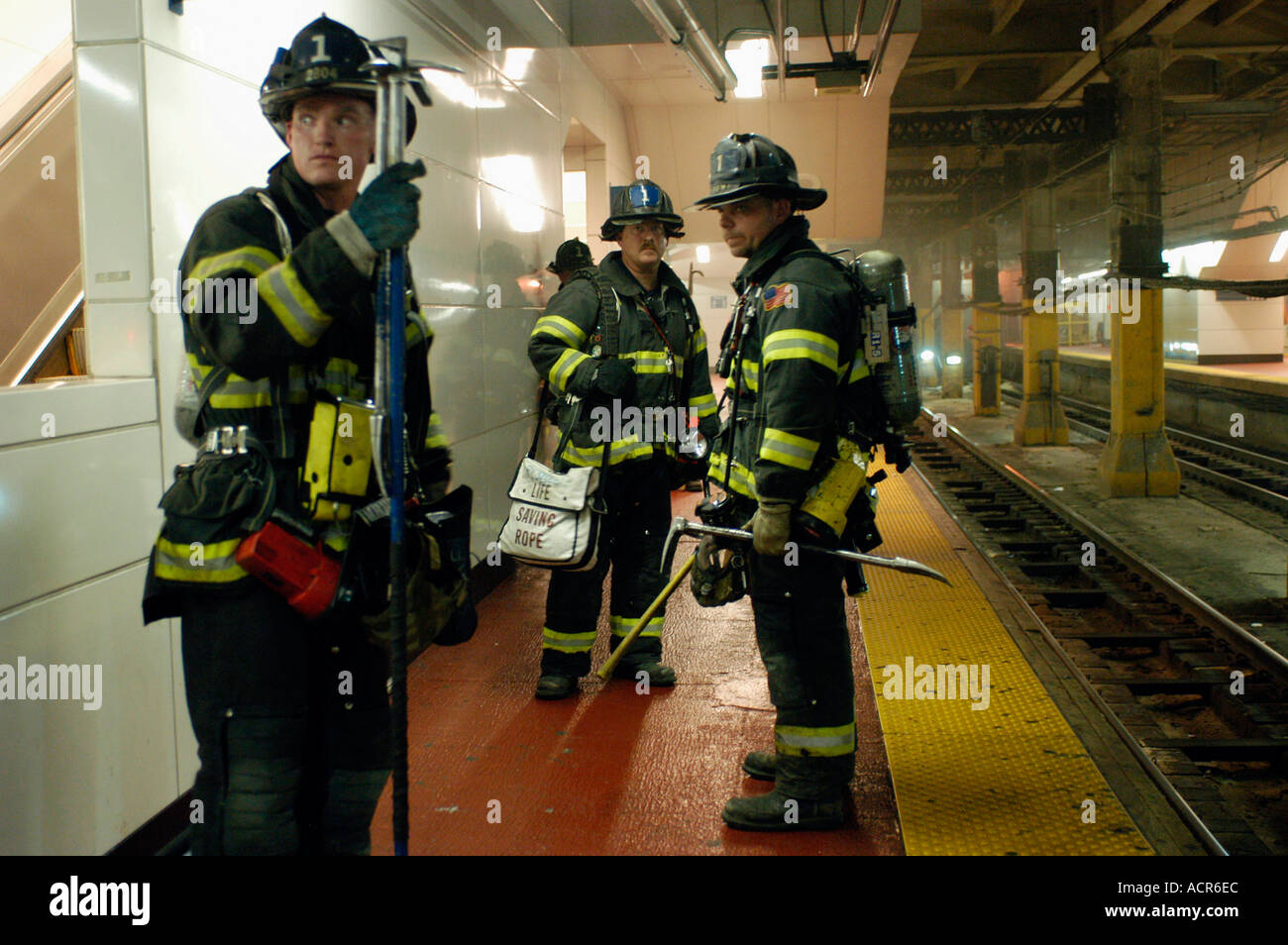 Firemen on the Long Island Rairoad platform during a fire at