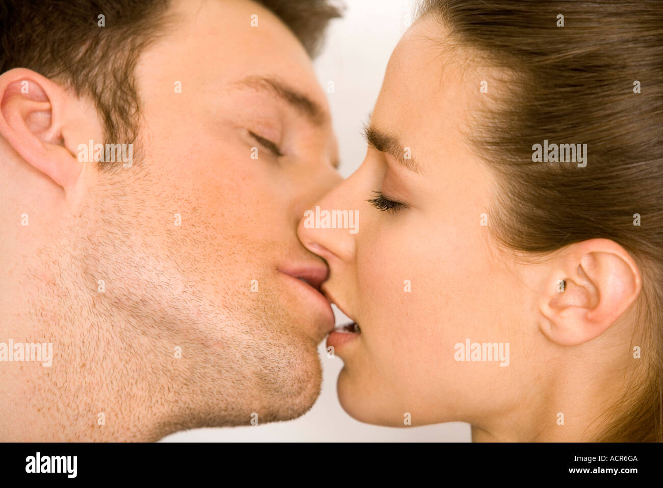 Young couple kissing, side view, close up Stock Photo - Alamy