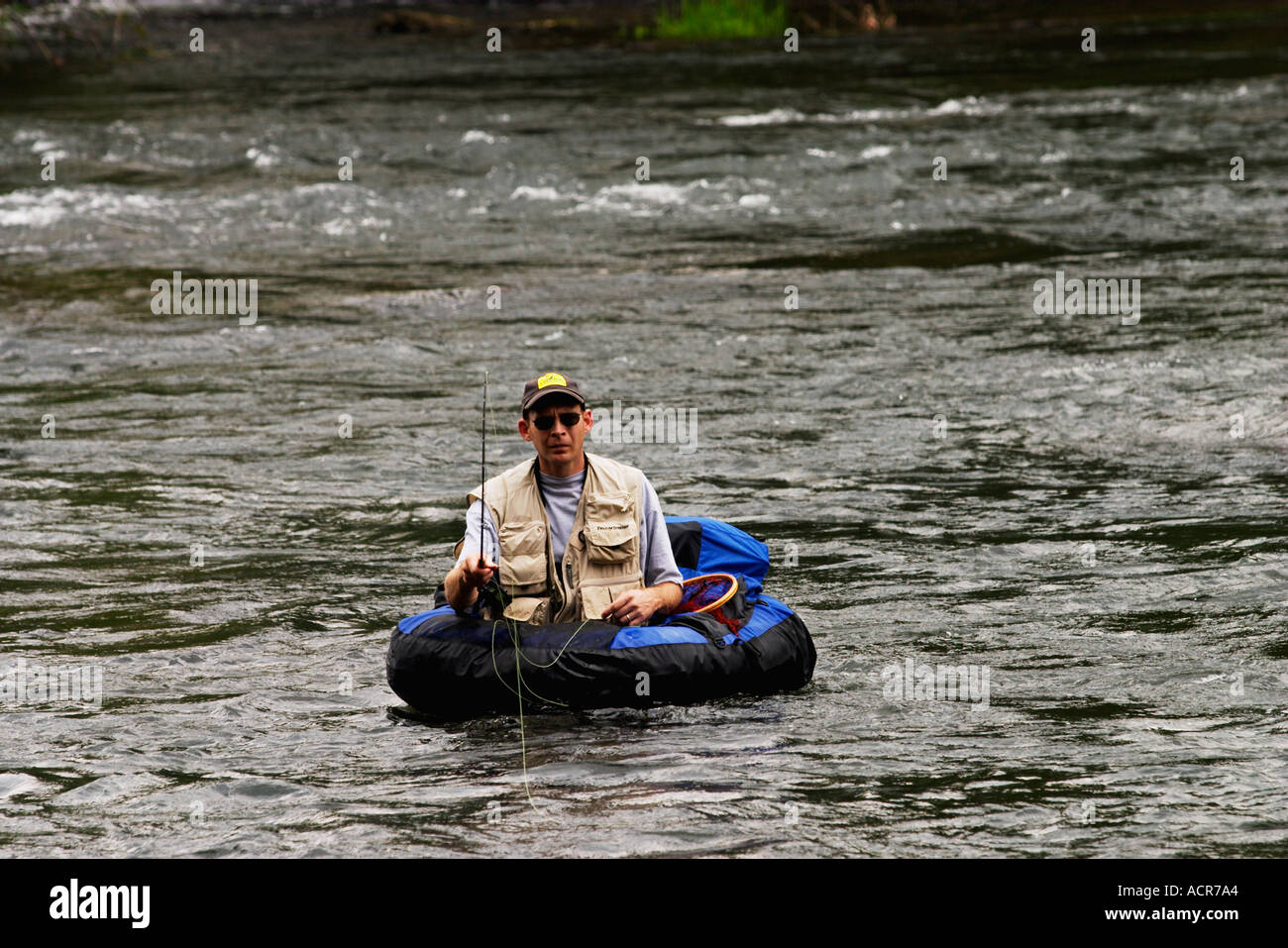 Fly Fisherman in float tube trout fishing the Hiwassee River Stock