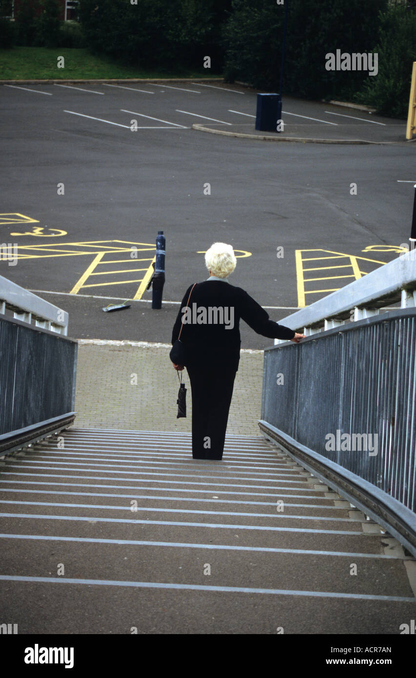 Elderley Woman Approaching Empty Car Park Stock Photo