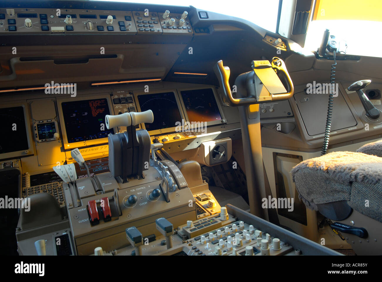 Flight instruments on an instrument panel in a cockpit of Boeing 777 aircraft, showing instrumentation dials and control yokes Stock Photo