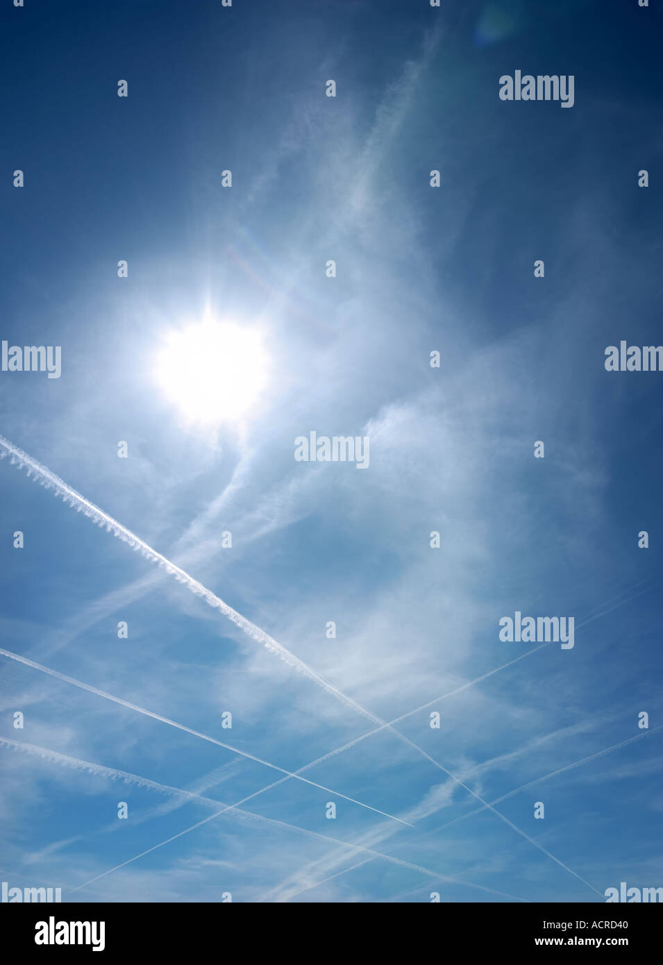 Multiple jet condensation trails crossing the sky Stock Photo Alamy