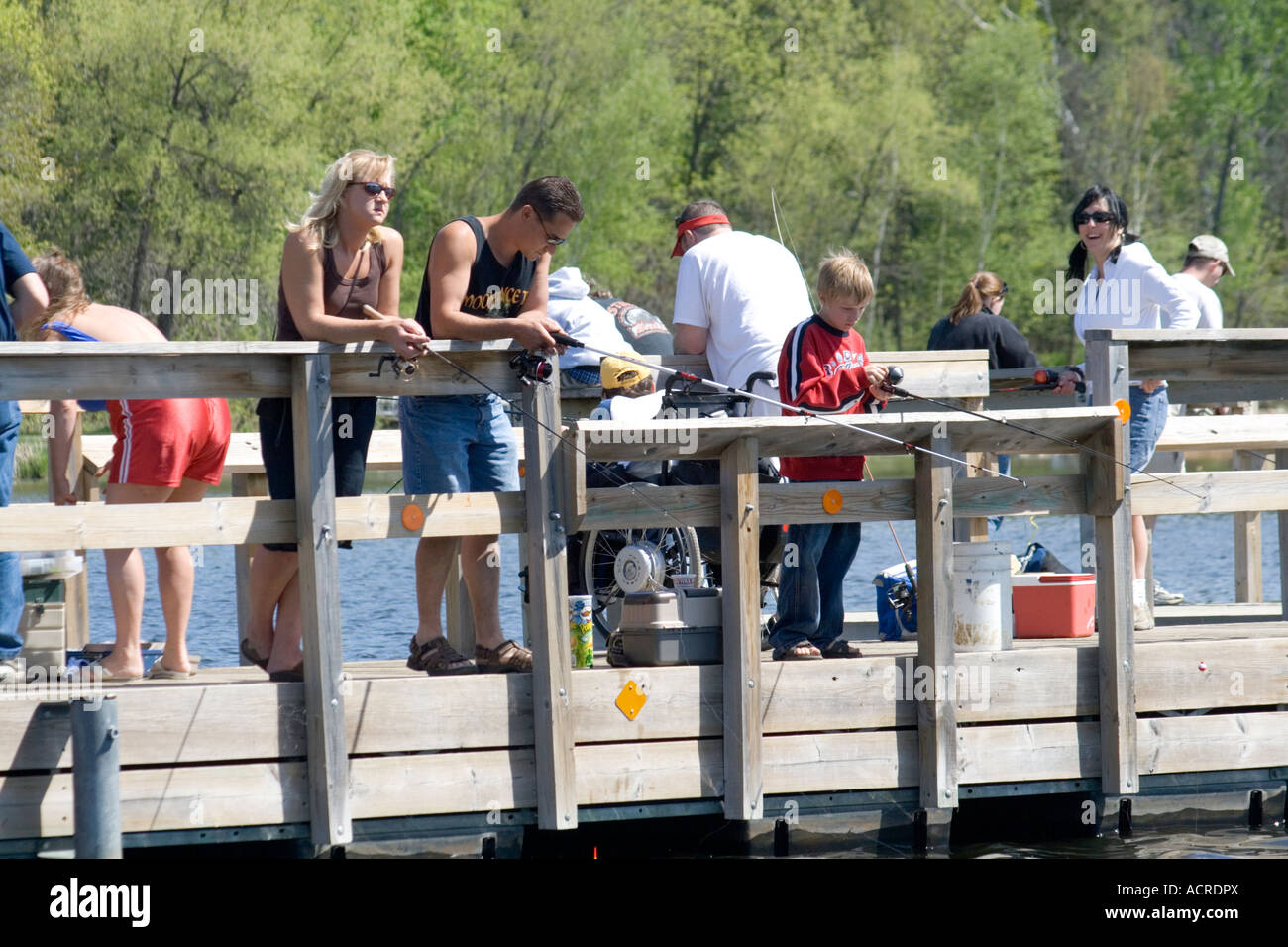Fishermen of all ages on Gull Lake pier.  Nisswa Minnesota USA Stock Photo