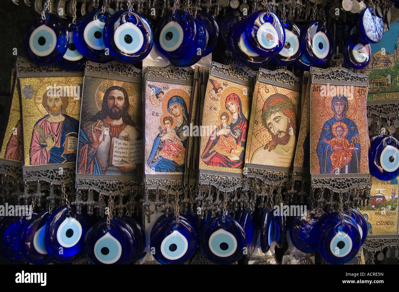 Christian hangings with protective evil eye amulets known as nazar boncuk in Turkish. Tourist gift stall Istanbul, Turkey Stock Photo
