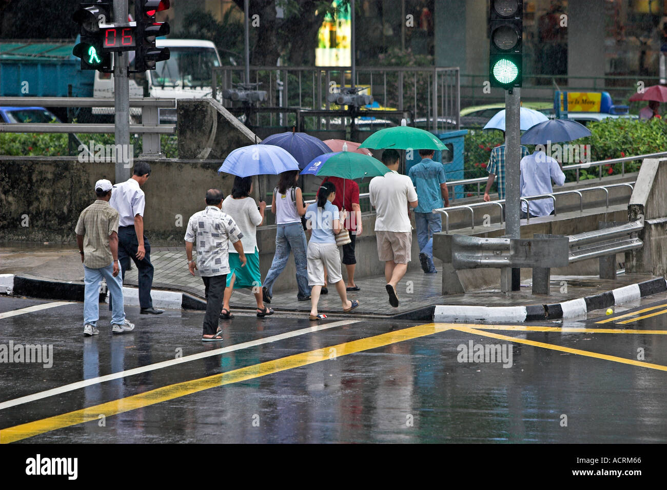 Pedestrians with umbrellas in rain Singapore Stock Photo - Alamy