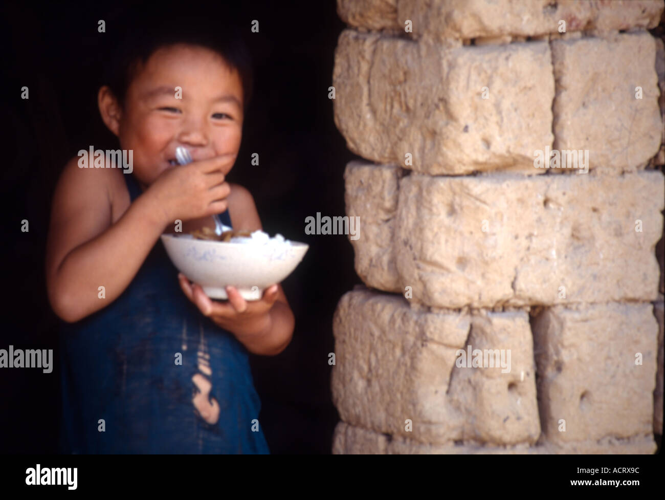 A boy is eating his bowl of rice. Stock Photo