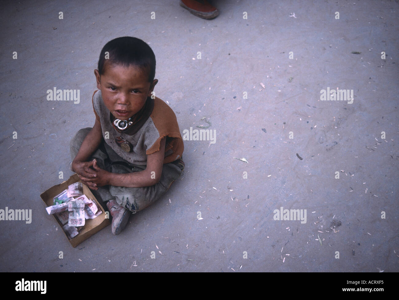 A little beggar in Barkhor Lhasa Tibet China Stock Photo