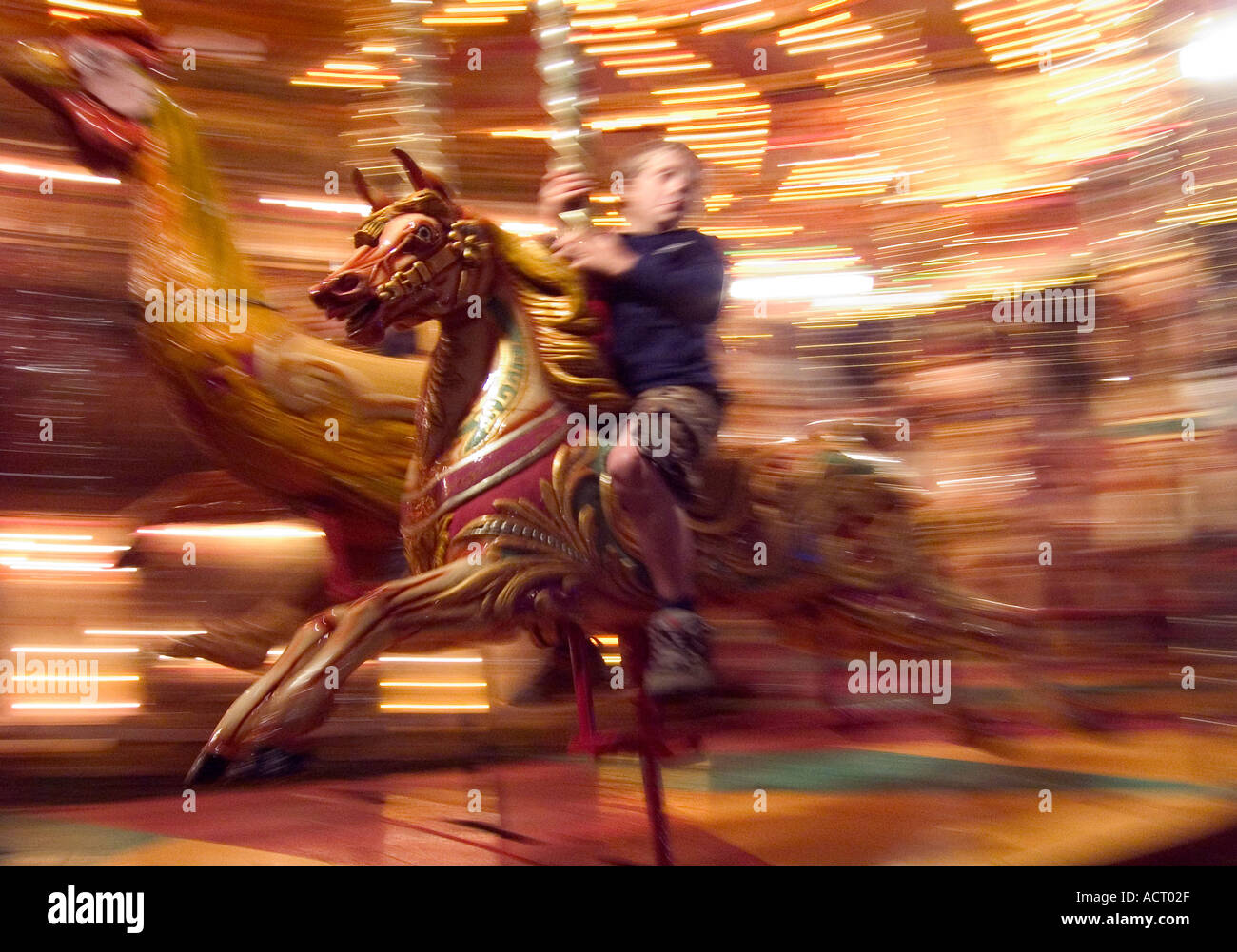 young boy on old fashioned fairground gallopers ride Stock Photo - Alamy