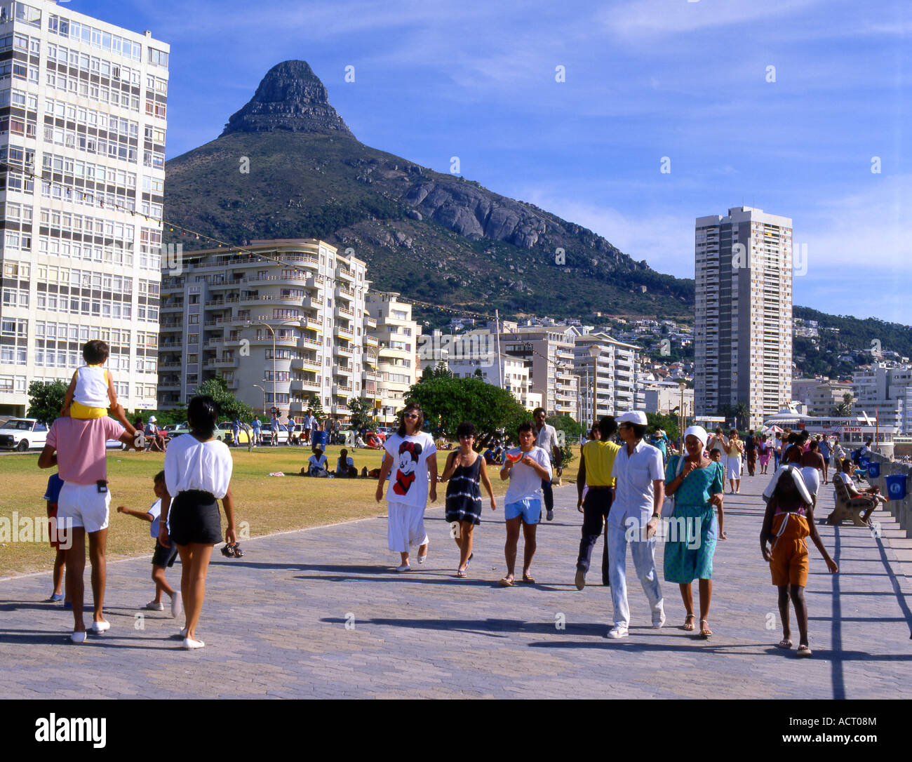Pedestrians and families stroll along the Beach Promenade in Sea Point on Cape town beachfront Cape Town Stock Photo