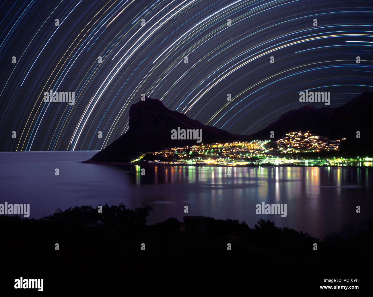 Houtbay at night with star trails showing across the night sky Hout bay Western Cape South Africa Stock Photo