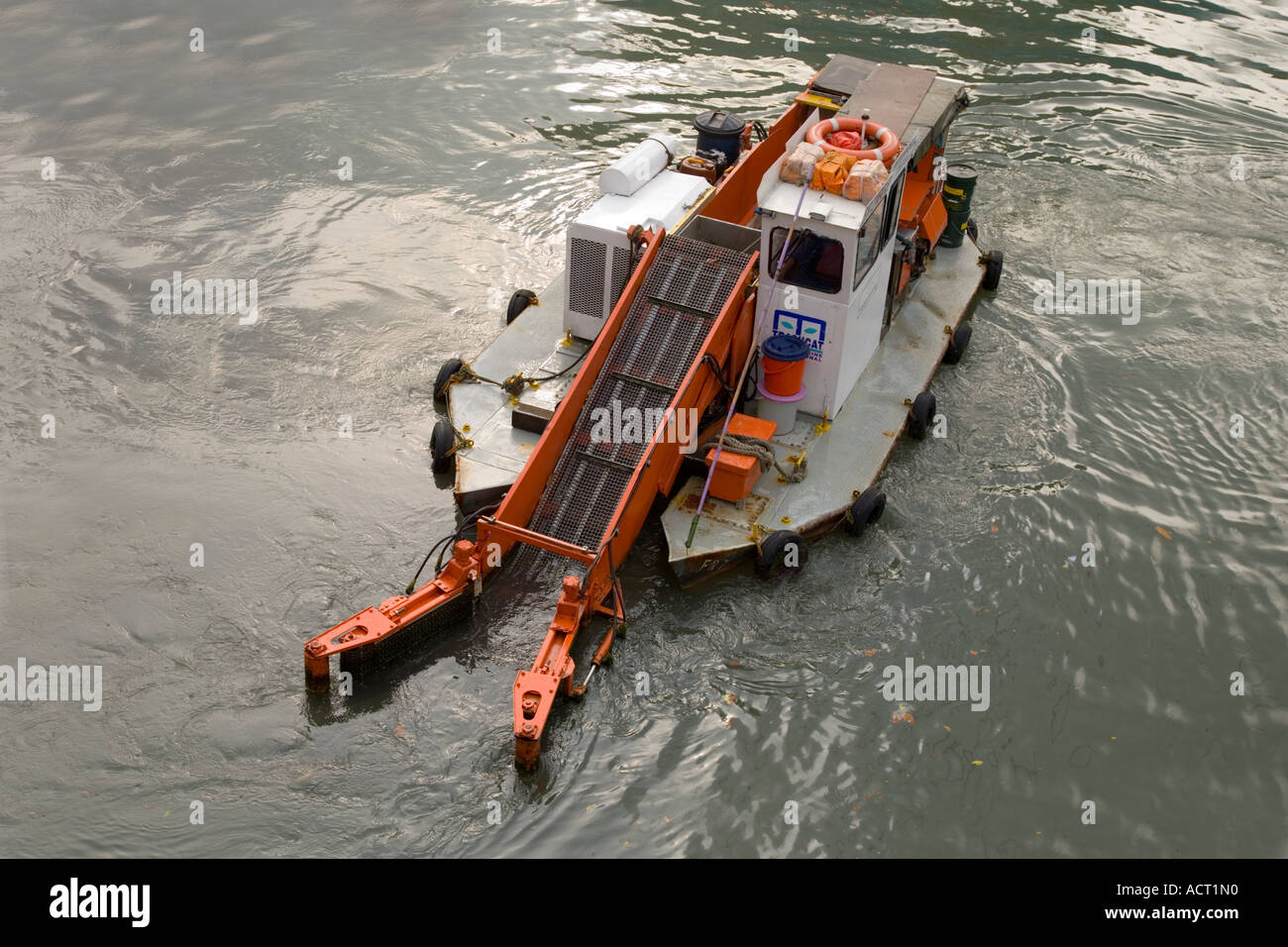 Boat used on Singapore River to clean up litter in the water Stock Photo